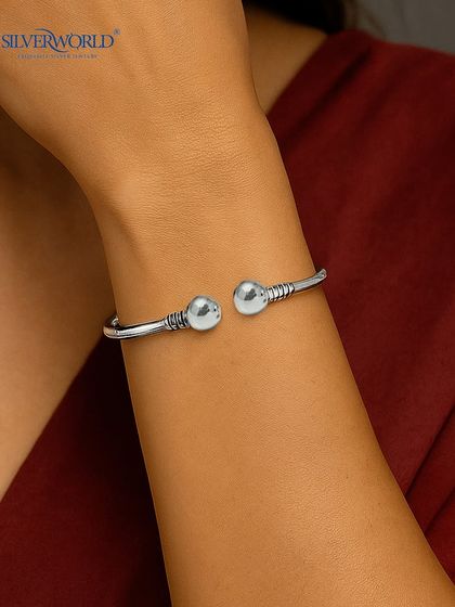 Our urban minimalist bangle is a classic open-ended design with ball accents and rustic detailing. It's a versatile and sturdy piece for everyday wear.