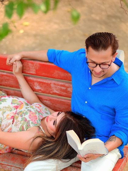 A close-up of a tender moment on the park bench. This shot focuses on their intimate connection and shared love for reading.