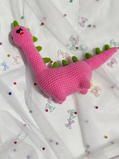 The full length of the Mrs. Dino plushie.