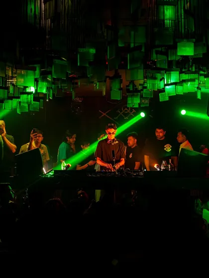 The view from the console at M Bar Kitchen in Kolkata. The green lights and packed crowd set the stage for a serious throwback session.
