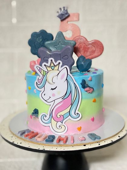 A zero-fondant unicorn cake, proving you don't need fondant for a magical design. This chocolate cake is decorated with colourful frosting and a beautiful unicorn topper.