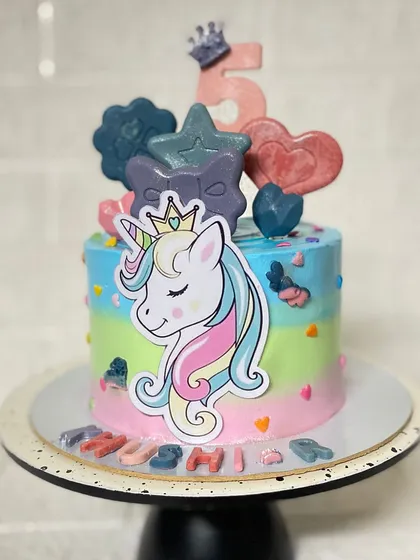A zero-fondant unicorn cake, proving you don't need fondant for a magical design. This chocolate cake is decorated with colourful frosting and a beautiful unicorn topper.