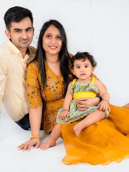 A classic family of three portrait. The warm yellow and cream color palette gives this photo a sunny and cheerful feel.