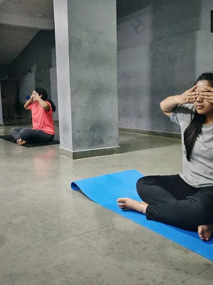 Here, we are practicing a technique to withdraw the senses and turn our focus inward. This is an important step in our classes to quiet the outside world before we settle into dhyaana, or meditation.