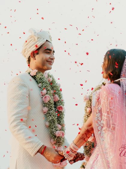 The groom looking at his bride with pure adoration during their Varmala ceremony.