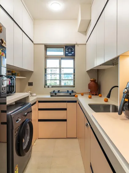 This compact kitchen layout makes the most of every inch, with ample storage, a dedicated spot for the washing machine, and plenty of counter space.