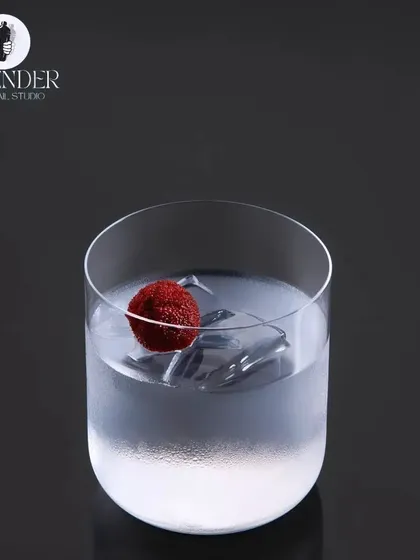 Excellence lies in the details. A crystal-clear drink with a single berry garnish showcases our belief in minimalist perfection.