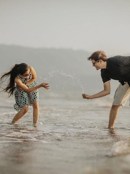 A fun and spontaneous moment of a couple splashing each other in the waves. I encourage playful interactions to capture your genuine smiles and laughter during the shoot.