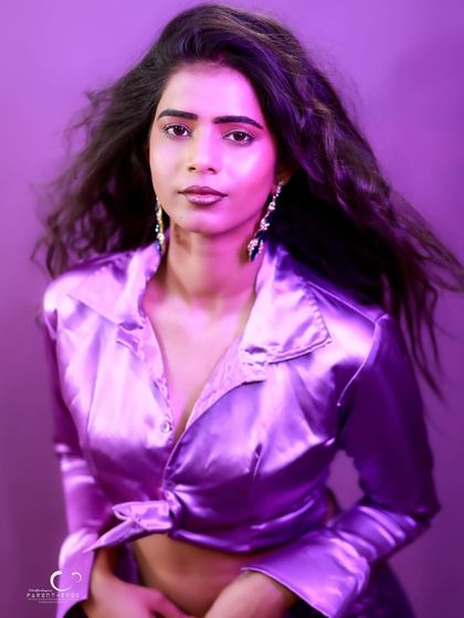 A classic beauty shot that highlights her features. The purple light adds a unique and artistic touch.