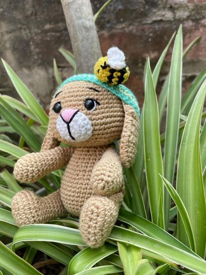 A side view of Oliver the Bunny. His long, floppy ears and sweet expression make him a classic and beloved character.