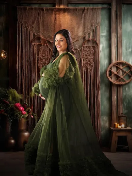 A beautiful portrait in an olive green gown against a rustic, wooden backdrop. The soft lighting and confident pose create a warm and elegant feel.