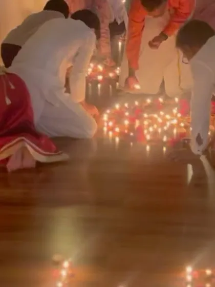 Students lighting diyas along the walls of the shala. There is nothing more divine than sharing the happiness of one's yoga sadhana with those who come seeking it. Each lamp is a prayer for collective growth.