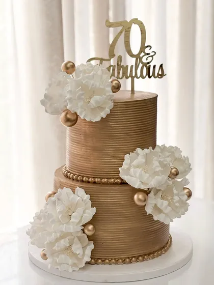 Seventy and fabulous! I adapted my classic golden tiered design with large, handmade white sugar peonies for a sophisticated and timeless 70th birthday cake.