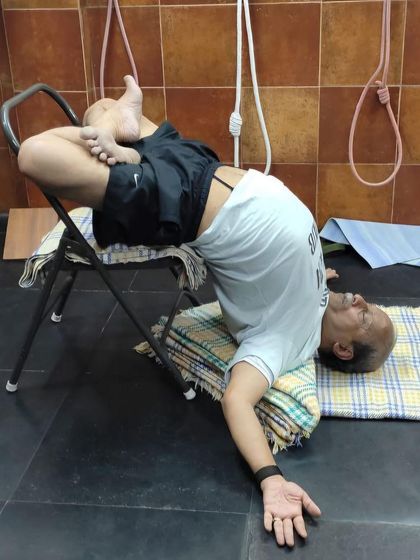 A supported backbend on a chair.