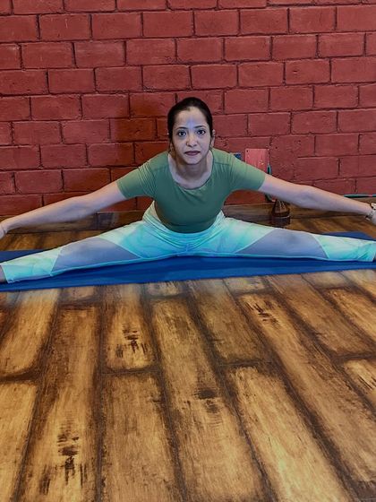The Wide-Angle Seated Forward Bend, or Upavistha Konasana, is excellent for opening the hips and stretching the inner thighs. During pregnancy, this pose can help prepare the pelvis for childbirth. We always use props to ensure the stretch is gentle and supported.