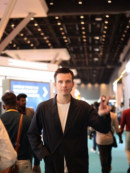 A candid shot of an international visitor navigating the busy expo floor, highlighting the global appeal and diverse audience of our event.