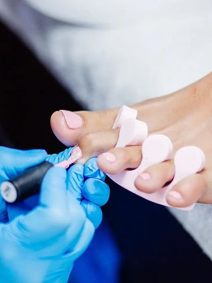A moment of pampering. Our technician applies a perfect coat of polish, giving your toes a fresh and vibrant look.