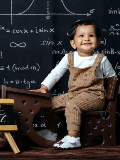 Classroom cuteness overload. This little scholar is all smiles at her tiny desk.