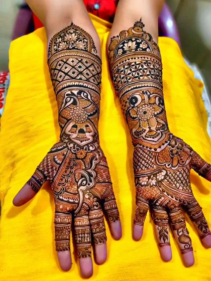 This design combines floral, peacock, and geometric patterns in a beautiful composition. The different elements flow into each other seamlessly from the fingers to the mid-arm.