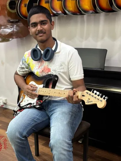 Meet our rockstar, Jose Fernandes, who is mastering the electric guitar with us. We offer comprehensive lessons for acoustic and electric guitar, guiding students through Trinity Rock and Pop exams and helping them find their unique sound.