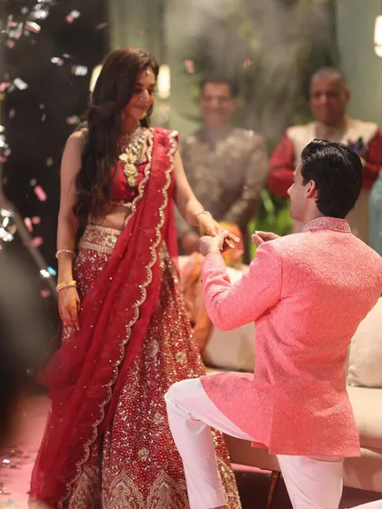 A romantic proposal moment captured during a sangeet performance. We can help you plan special surprises within your choreography.