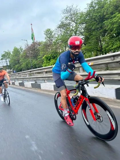A rider in his Ironman triathlon jersey, showing his athletic prowess.
