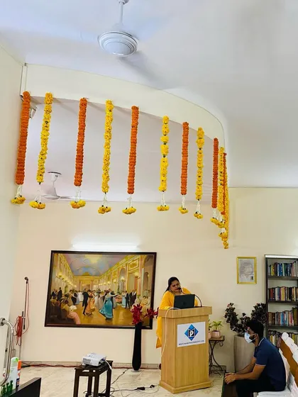 For corporate events like seminars or conferences, I create simple yet elegant ceiling decorations. These vertical flower strings of fresh marigolds hang above the main stage or podium area, adding a special touch without being distracting.