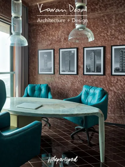The cabin/office space features a custom marble desk and bold teal leather chairs, all set against a rich, textured wall. The large window offers an inspiring view of the sea, making it a great place to work.