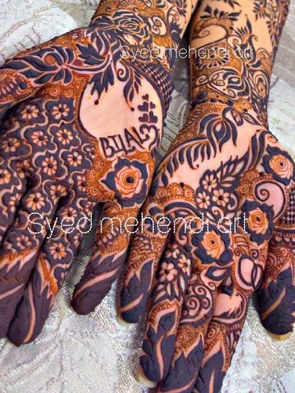 A detailed engagement design with the name "Bilal" and hearts incorporated into the palm.