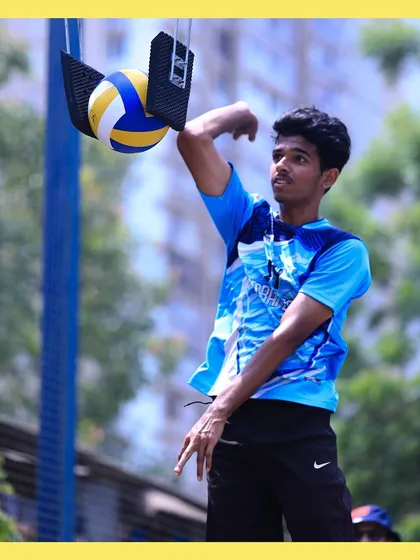 A player practices his arm swing and timing, getting ready to unleash a powerful hit on the stationary ball.