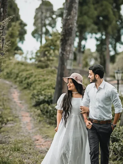 A romantic stroll through a wooded path in Darjeeling. The couple's happy expressions and the natural setting create a charming and heartwarming pre-wedding photograph.