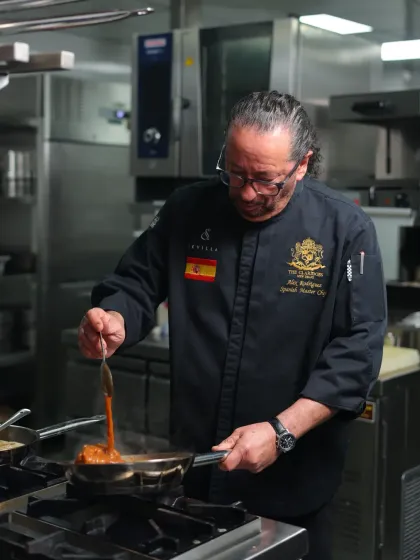 In my kitchen, every dish is prepared with cariño, or love. Here, I am preparing a sauce, ensuring that every ingredient speaks of its Spanish heritage and contributes to a memorable flavour.