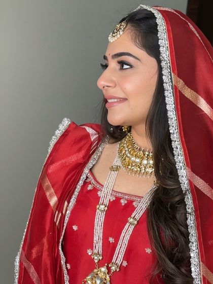 A side profile of Rashmi's Anand Karaj look, highlighting the clean lines of her winged eyeliner and the beautiful simplicity of the makeup. It's a perfect example of less is more.