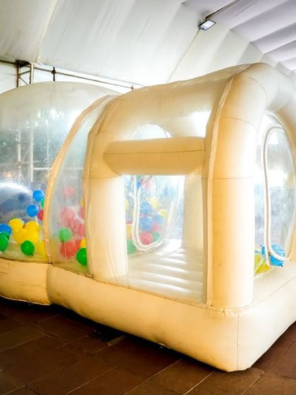 Another view of our inflatable bubble house, this one filled with multi-colored balls, offering a different kind of sensory play experience.