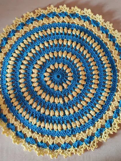 A slightly different angle of the blue and yellow doily.
