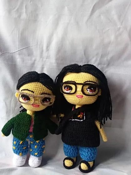 A custom doll pairing I made for a client, capturing their likenesses from photos, including their distinct hairstyles and glasses.