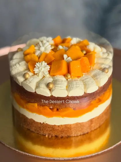 A beautiful layered mango "pull-me-up" cake, with exposed layers of sponge, cream, and fruit.