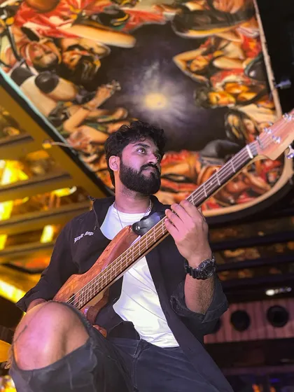 Our bass maestro, holding down the low end. He cranks up the grooves so hard that every note makes you want to headbang.