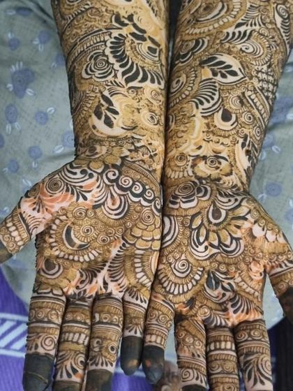 This design shows a beautiful blend of different textures. The fine lines of the paisley and floral motifs are contrasted with the simple, clean lines of the finger details.