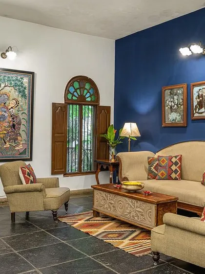 The Vasishta suite's living area, with its deep blue wall and curated artwork, provides a sophisticated and calming space.