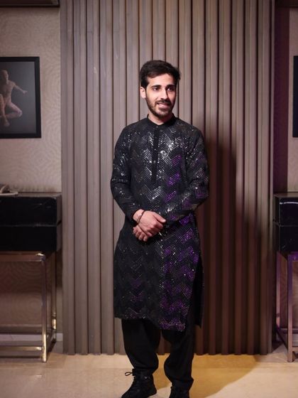 For the brother of the bride's cocktail look, we went with a custom-made jazzy black kurta set. It was the perfect choice to match the party vibe while still looking sharp and put-together.