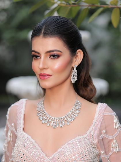 A dash of shimmer and she shines like a dream. This close-up highlights the soft, blended eyeshadow and luminous skin that define this modern engagement look.