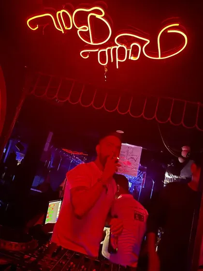 Under the iconic red neon of Radio Bar. Spinning at different venues across Mumbai keeps my sets dynamic and my music knowledge sharp.