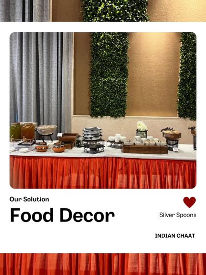 The food decor and setup for an Indian chaat station. The combination of a neat buffet line, fresh greenery, and organized dishes creates a welcoming display.