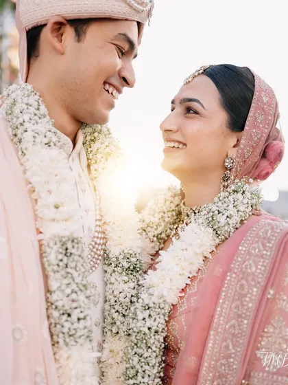 Bathed in the warm glow of the setting sun, this intimate portrait captures the pure love between the bride and groom.