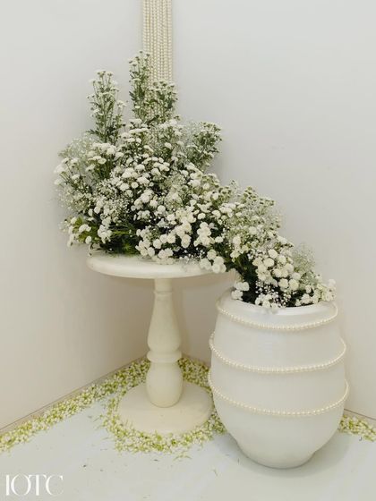 A corner from the intimate home wedding, featuring a pearl-adorned vase and a side table with cascading baby's breath, showcasing our attention to detail even in the smallest spaces.