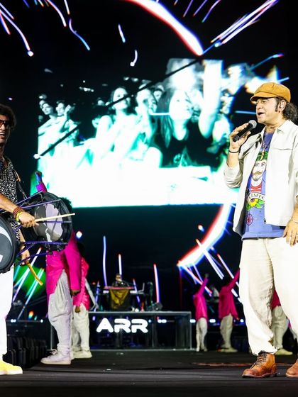 Mohit Chauhan and another artist share the stage. The background LED screen shows a live feed of the audience, a technique we use to create a deeper connection between the performers and the crowd.