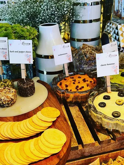 Our dip station at a baby shower, offering a variety of house-made options like muhammara and different types of hummus, each clearly labeled.