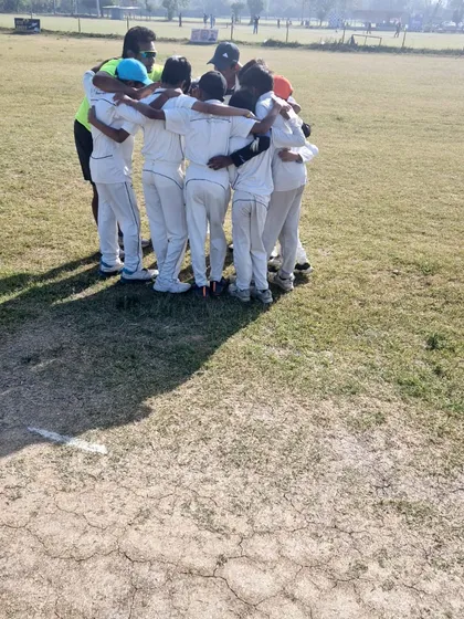 Another angle of our team huddle, showing the unity and focus before taking the field. We emphasize that every player has a role to play in the team's success.