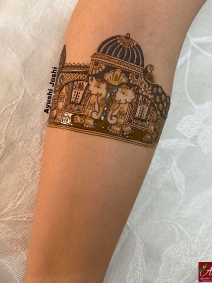 A startup idea for a bridal armband featuring two elephants inside a palace, with a peacock on the side. This is a classic and popular composition.